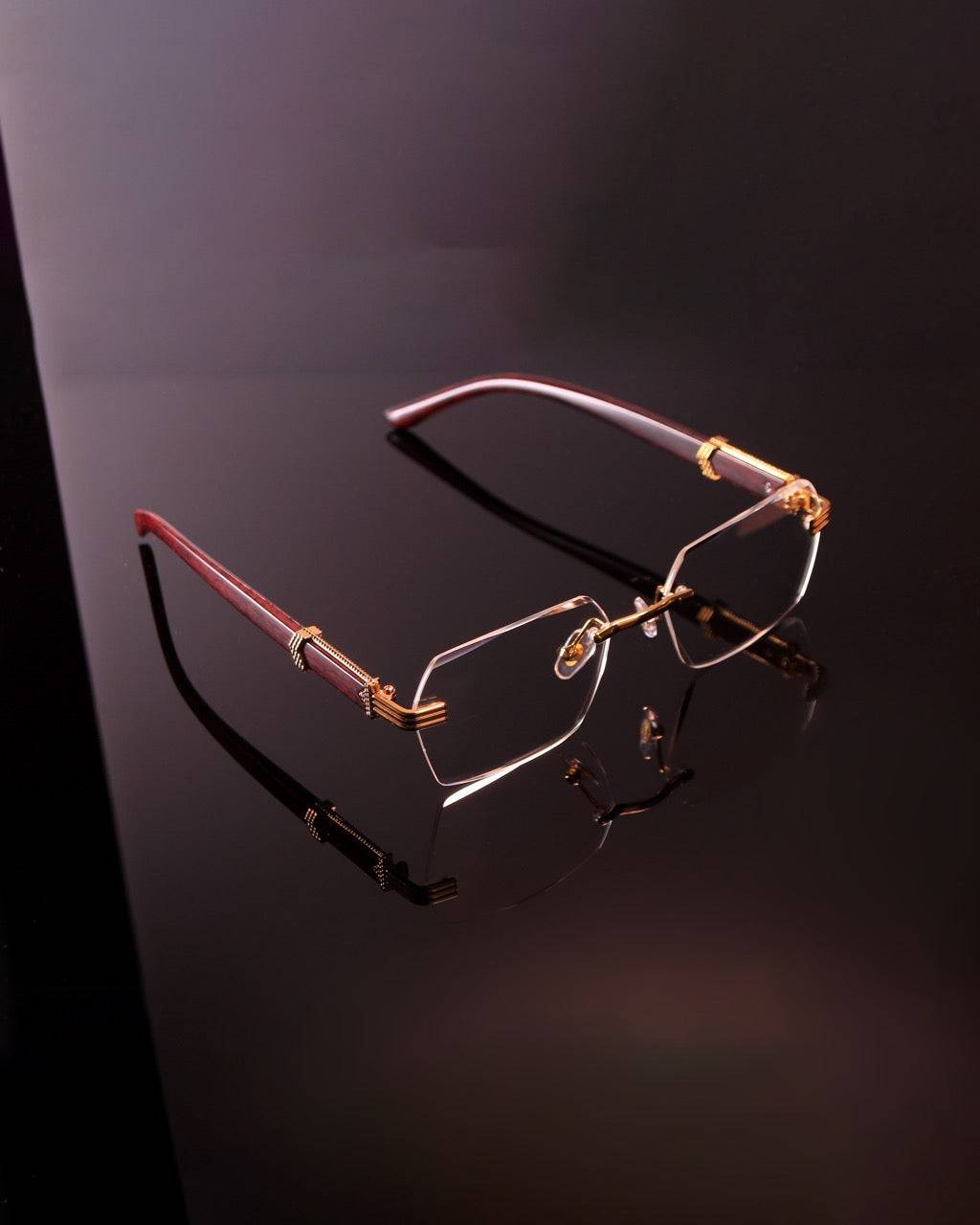 Lunettes Elite Eyewear sans contour avec verres transparents et branches rouges, design audacieux pour un été stylé.
